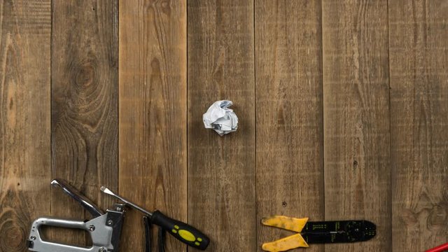 Hand tools animation on wooden table for brand logo on white sheet. Theme stop motion hand tools for logo intro. Concept of brand promotion for provision of repair services, locksmith or woodworker.