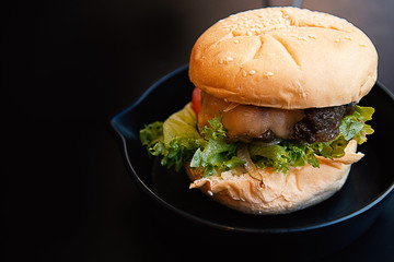 Hamburger on iron pan  image for food content.