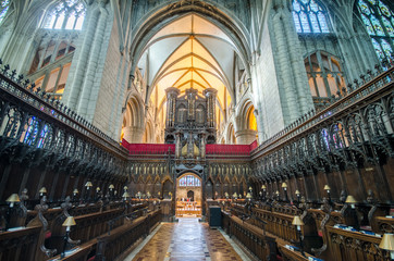 Great organ in Gloucester Cathedral UK high up between the choir and the nave 