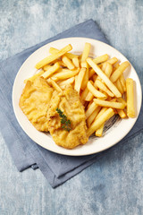 Pork Schnitzel with french fries on wooden background. 