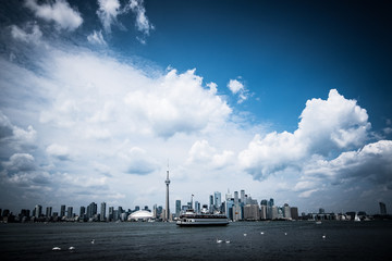 A high-contrast view of the Toronto skyline with a dramatic sky covered in clouds, Toronto, Ontario, Canada