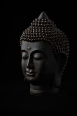 Buddha Statue (close-up). Black background. 