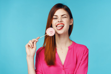 portrait of young woman with lollipop on white background