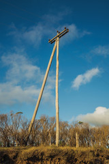 Fototapeta na wymiar Wooden light poles on rural landscape
