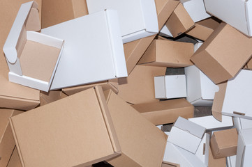 Stacks of brown and white cardboard boxes isolated on white background