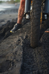 Fototapeta na wymiar Close up motorbike tire and track on the black sand
