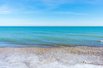 Fototapeta na wymiar Beautiful turquoise colored water along Lake Michigan shoreline in winter
