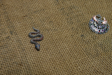 Handcrafted antique brooches  in the shape of a peacock and snake with colorful stones 