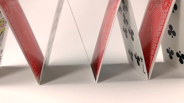 House made of playing cards isolated on a white table, SLIDE