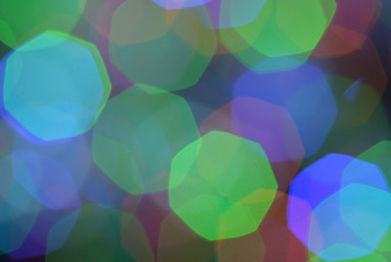 Bokeh of large Christmas multifaceted multicolored lights with blur background.