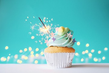 cupcake with icing and sprinkles on white background
