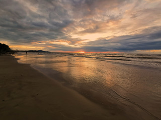 Dramatic clouds during sunset on the beach.