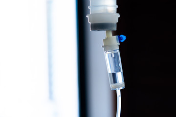 Normal saline bottle hanging from stand in hospital.  Health care and medical concept.