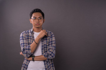 Asian boy or student with serious face reaction .Copy space.