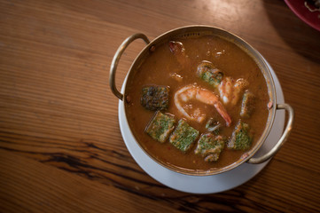 Cha-om sour soup with shrimp in the pot.