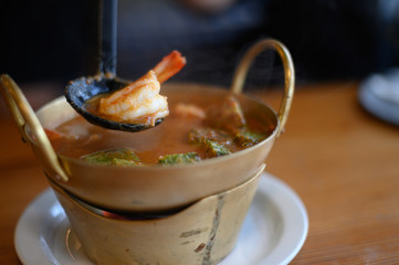 Cha-om sour soup with shrimp in the pot.