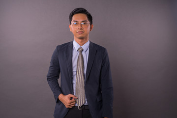 Confidence young intrepreneur or business man with copy space.Studio shot.