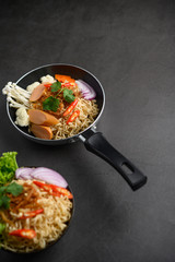 The style still life with noodles in the pan.