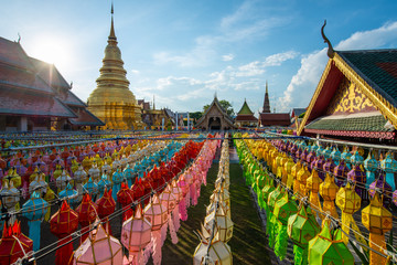 Wat Phra That Hariphunchai with traditional paper lanterns hanging on the rows during Yi peng (or Yee peng) festival in Lamphun province of Thailand.