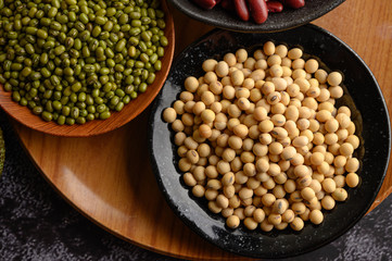 Mung bean and Soy bean on the plate on a black cement floor background.