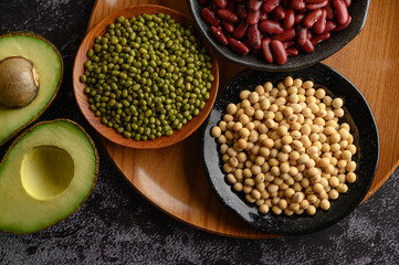 legumes and fruit on a black cement floor background.