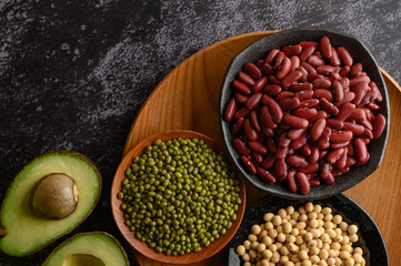 legumes and fruit on a black cement floor background.