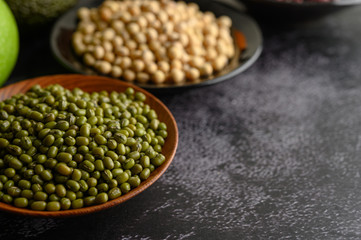 Mung bean and Soy bean on the plate on a black cement floor background.