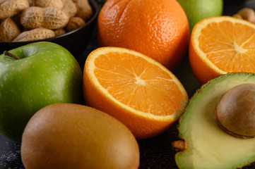 close up with Slice of fresh orange apple, kiwi, peanut, and avocado.