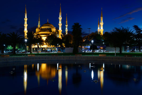 Blue Mosque lit at dusk with reflection in fountain Istanbul Turkey