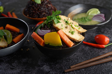 Purple rice berries cooked with grilled chicken breast. Pumpkin, carrots, and mint leaves in a dish, clean food.