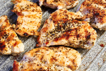pieces of fried chicken breast. Grilled poultry steak cooked on a grill pan