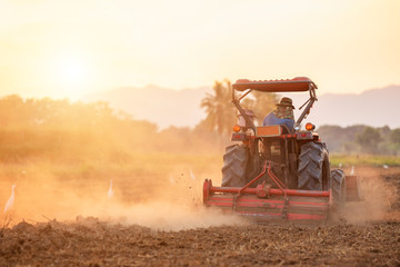 Thai farmer on big tractor in the land to prepare the soil