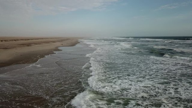 4K aerial drone video view of Namibian Atlantic coastline, Zeila L-758 Walvis Bay stranded rusty shipwreck at sand beach in Skeleton Coast Park landscape with ocean background at Namibia's west coast