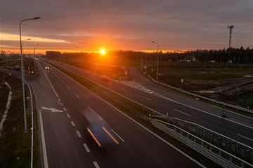 car traffic on the newly built section of the S6 expressway in Poland during sunset