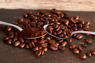 Teaspoons with coffee beans and ground coffee