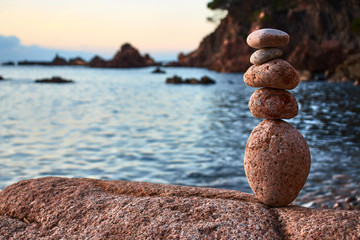 Five balanced stones by the sea