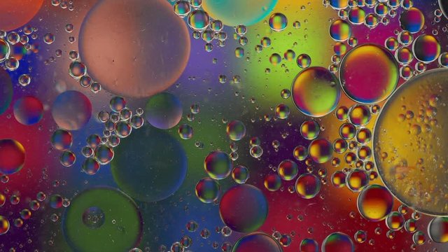 Large, medium and small bubbles slowly moving around, slow motion