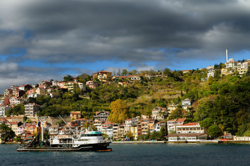 Seine fishing boat on the Bosphorus Strait with houses on hill at Yeni Mahalle Sariyer Turkey