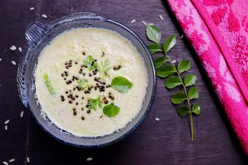 Coconut Chutney, South Indian side dish served with Idli and Dosa over black background, Moody photography