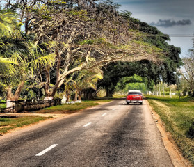 Classic american car on the road from Trinidad to Matanzas in Cuba