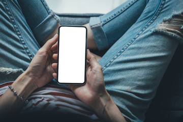 Mockup image blank white screen cell phone.woman hand holding texting using mobile at coffee shop.background empty space for advertise text.people contact marketing business,technology 