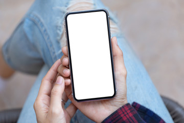 Mockup image blank white screen cell phone.woman hand holding texting using mobile at coffee shop.background empty space for advertise text.people contact marketing business,technology 