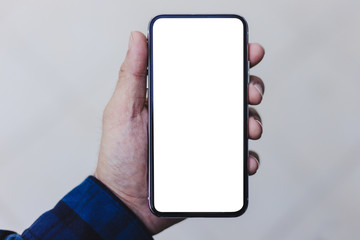 Mockup image blank white screen cell phone.man hand holding texting using mobile.background empty space for advertise text.people contact marketing business,technology 