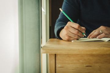 high school,university student study.hands holding pencil writing paper answer sheet.sitting lecture chair taking final exam attending in examination classroom.concept scholarship for education abroad