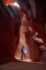 Happy couple moslem posing exploring inside the Grand Canyon, eroded sandstone rock in slot canyon, antelope valley, page, arizona, usa. 