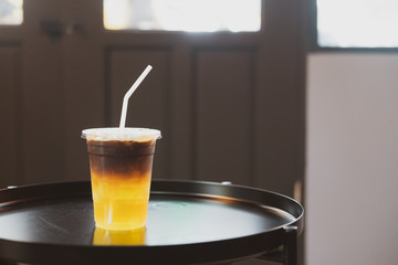 Glass of espresso shot mixed with sparkling soda and orange juice