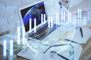 Financial market graph hologram and personal computer on background. Double exposure. Concept of forex.