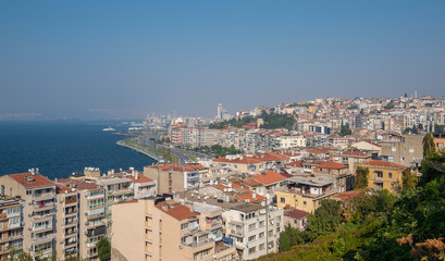 View over Konak district of Izmir, Turkey, with residential buildings. Gulf of Izmir on the Aegean Sea and the seaport terminal. 