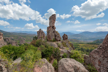 Fototapeta na wymiar Beautiful landscape with bizarre rock formations. Stone stairs leading to the amazing rock formations and walls of a medieval fortress in Belogradchik, northwest Bulgaria. Panorama