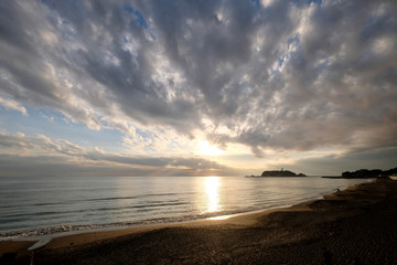 Fototapeta na wymiar bright sunset of Enoshima island in Kanagawa Japan. Sea waves against coastline. Wide angle